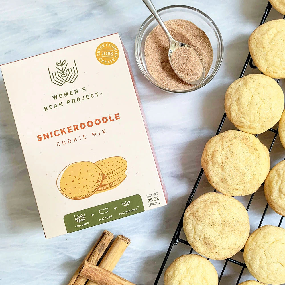 Women's Bean Project Snickerdoodle cookie mix next to a rack of freshly baked snickerdoodle cookies